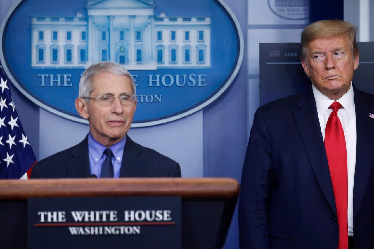 FILE PHOTO: President Trump looks at Dr. Anthony Fauci as Fauci addresses the daily coronavirus response briefing at the White House in Washington