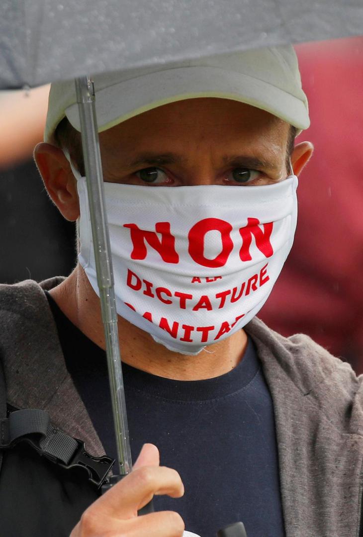 Protest against the coronavirus disease (COVID-19) restrictions in Paris A protester wears a protective face mask which reads " No to sanitary dictatorship " during a demonstration against the coronavirus disease (COVID-19) restrictions, in Paris, France, August 29, 2020.  REUTERS/Charles Platiau CHARLES PLATIAU