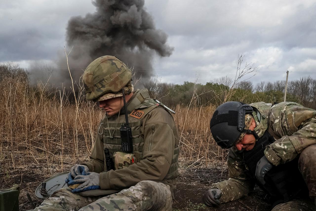 Member of the National police special demining unit blow up ant-tank mines during a demining operation near Izum