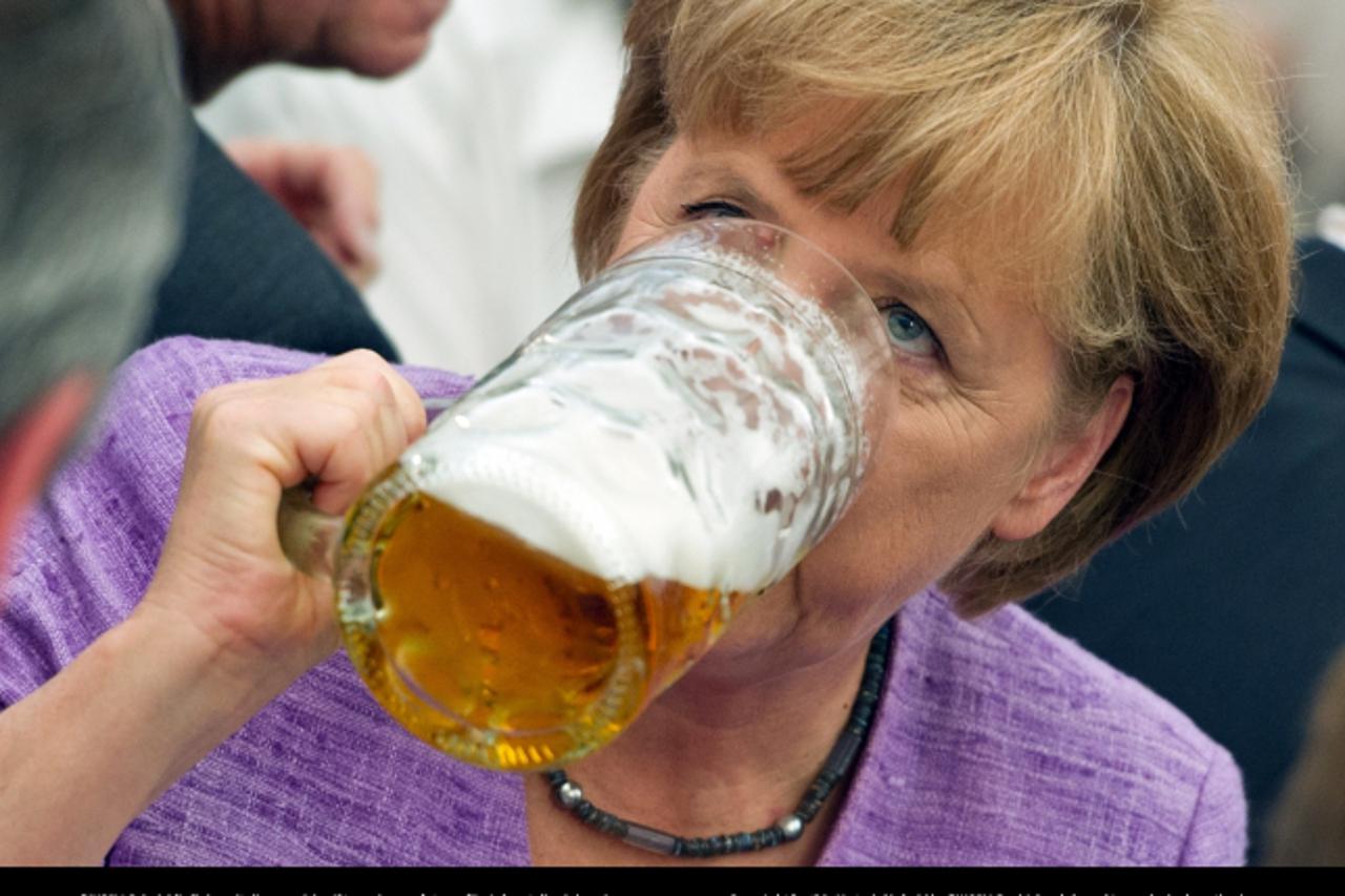 'German Chancellor Angela Merkel drinks beer during the Gillamoos political morning pint in Abensberg, Germany, 03 September 2012.  Gillamoos is one of the biggest and oldest fairs in Lower Bavaria. A