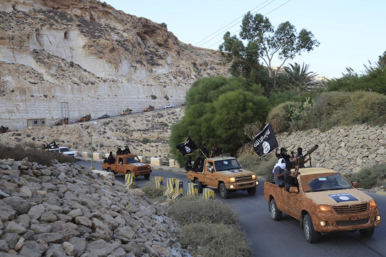 An armed motorcade belonging to members of Derna's Islamic Youth Council, consisting of former members of militias from the town of Derna, drive along a road in Derna, eastern Libya October 3, 2014. The group pledged allegiance to the Islamic State on Oct