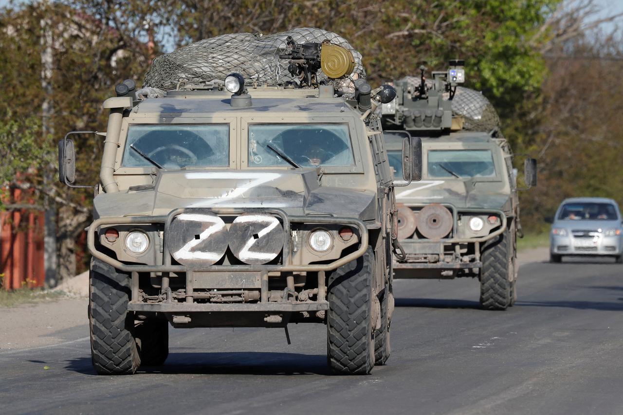All-terrain armoured vehicles of pro-Russian troops drive along a road in the Donetsk region