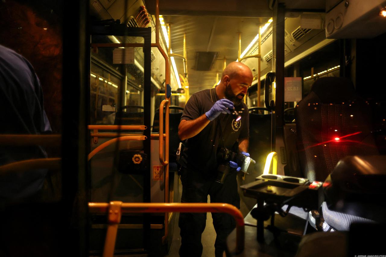 An Israeli police officer checks a bus following an incident in Jerusalem