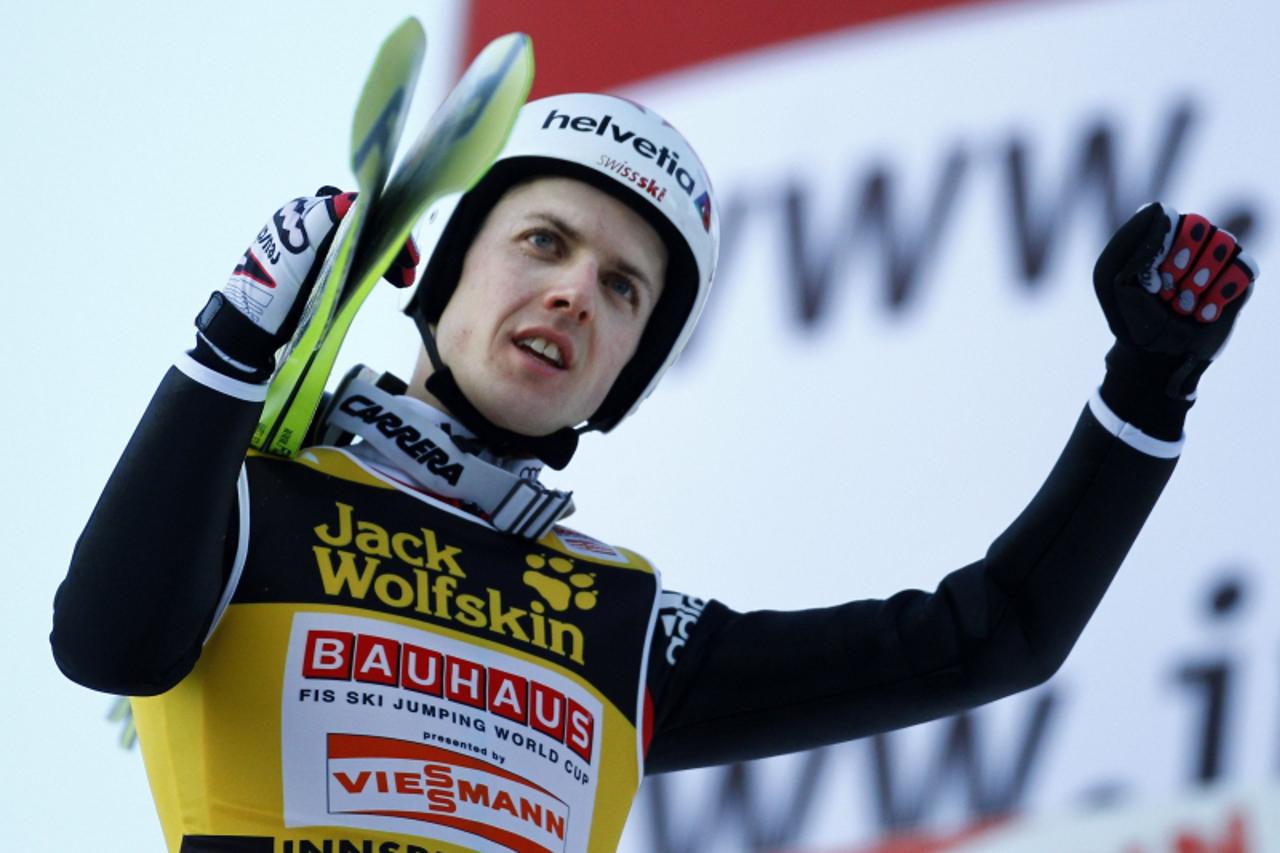 'Switzerland\'s World Cup overall leader Simon Ammann reacts after taking the second rank in the third event of the four-hills ski jumping tournament in Innsbruck, January 3, 2010. Austria\'s Gregor S