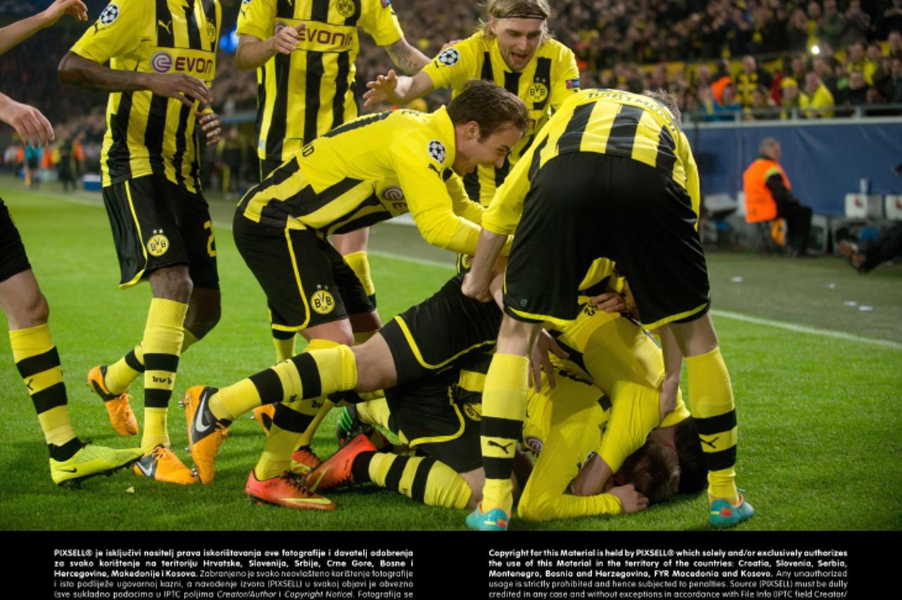 'Dortmund\'s Jakub Blaszczykowski (bottom, hidden) celebrates with his teammates the 3:0 during the UEFA Champions League round of 16 second leg soccer match between Borussia Dortmund and Shakhtar Don