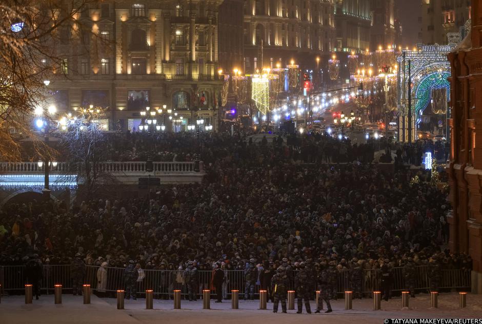 People gather to watch fireworks at the Manezhnaya Square during the New Year's celebrations in Moscow