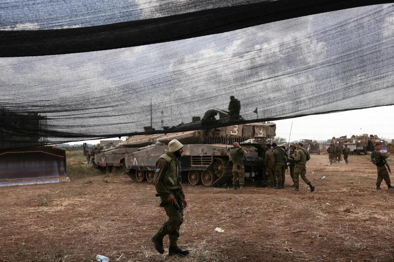 Israeli soldier walks in an area near Israel's border with the Gaza Strip, in southern Israel