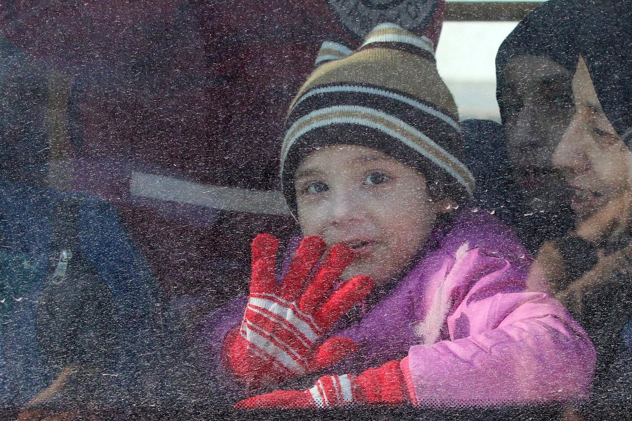 A child reacts from inside a bus evacuating people from a rebel-held sector of eastern Aleppo, Syria December 15, 2016. REUTERS/Abdalrhman Ismail     TPX IMAGES OF THE DAY