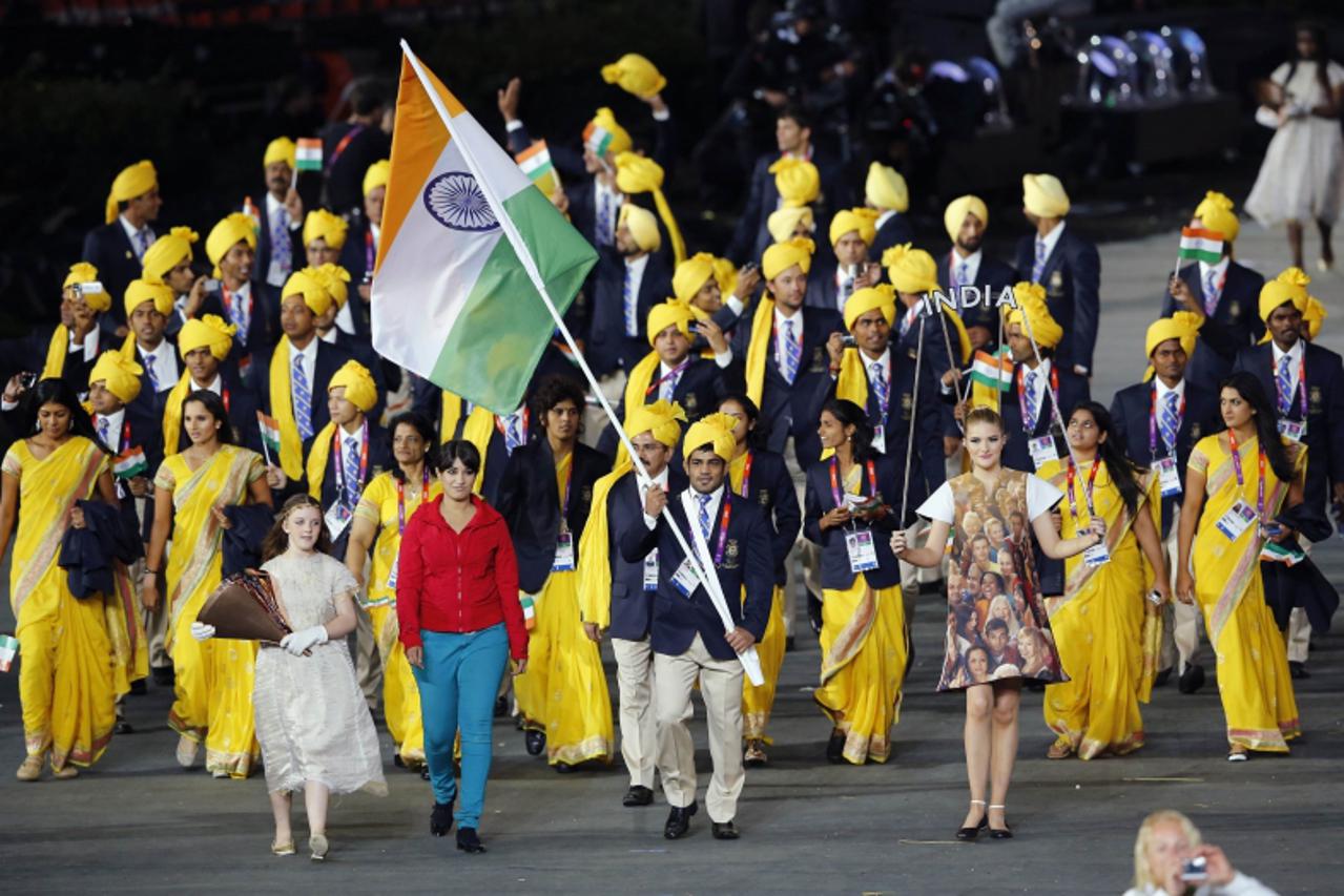 'India\'s flag bearer Sushil Kumar holds the national flag as he leads the contingent in the athletes parade during the opening ceremony of the London 2012 Olympic Games at the Olympic Stadium July 27