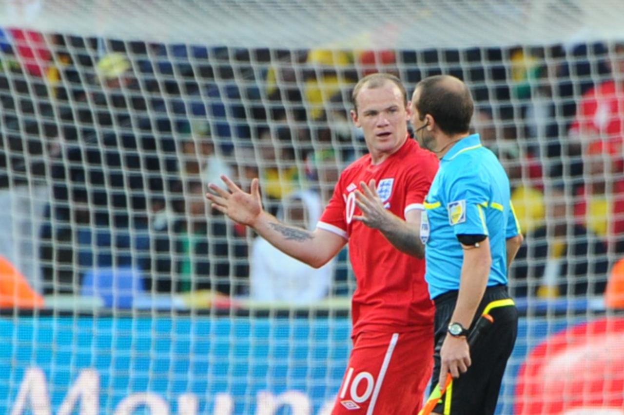 'Uruguayan referee Jorge Larrionda (R) talks with England\'s striker Wayne Rooney during the 2010 World Cup round of 16 match Germany vs England on June 27, 2010 at Free State stadium in Mangaung/Bloe