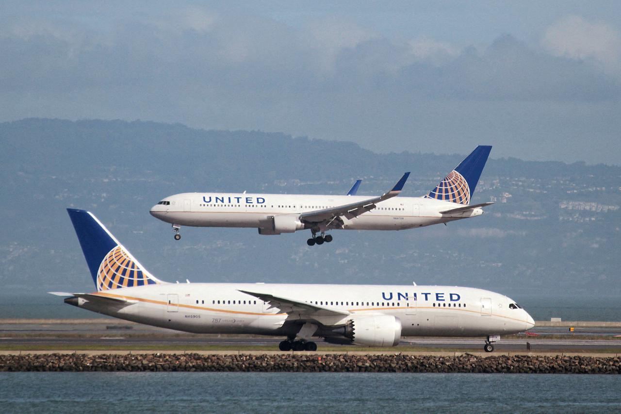 FILE PHOTO: A United Airlines 787 taxis as a United Airlines 767 lands at San Francisco International Airport, San Francisco