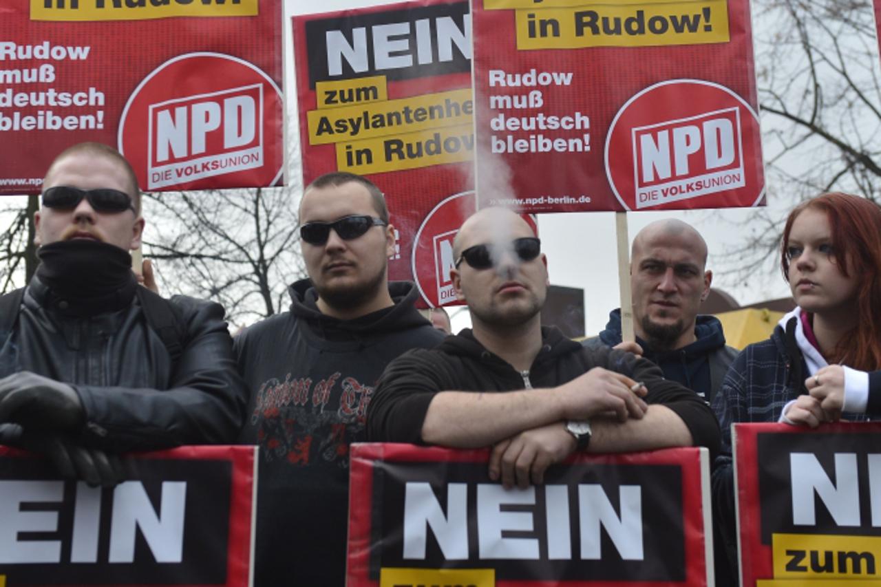 'TO GO WITH AFP STORY BY Eloi ROUYER  (FILES) - Picture taken  on November 24, 2012 shows supporters of German far-right party NPD (National Democratic Party of Germany) holding placards reading 'No 
