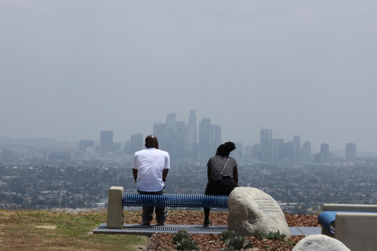 People look at the downtown skyline on a hot hazy day in Los Angeles