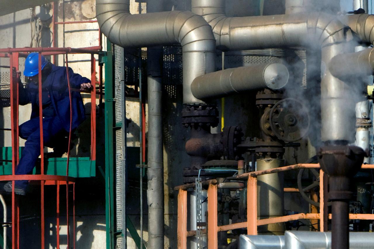 FILE PHOTO: Employee works at Repsol YPF's refinery plant in Cartagena