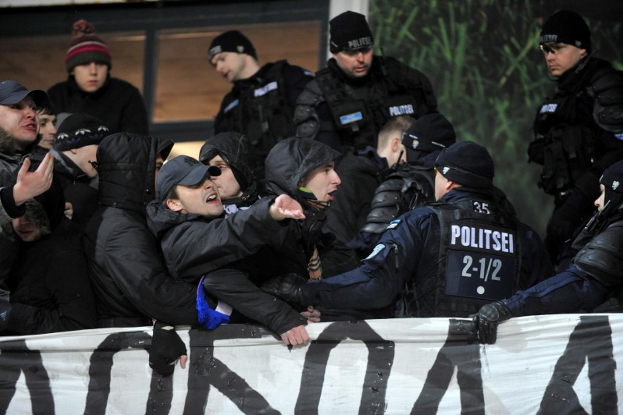 'Serbian supporters clash with security forces during the Euro 2012 Group C qualifying football match Serbia versus Estonia on March 29, 2011 in Tallinn. AFP PHOTO / RAIGO PAJULA  -ESTONIA OUT-'