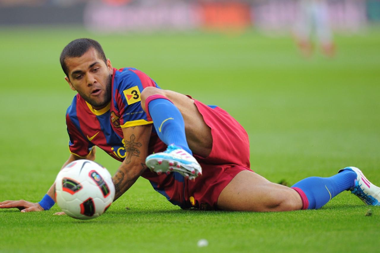 'Barcelona\'s Brazilian defender Dani Alves plays with a ball during the Spanish League football match between FC Barcelona and RCD Espanyol on May 8, 2011 at Camp Nou stadium in Barcelona. AFP PHOTO/