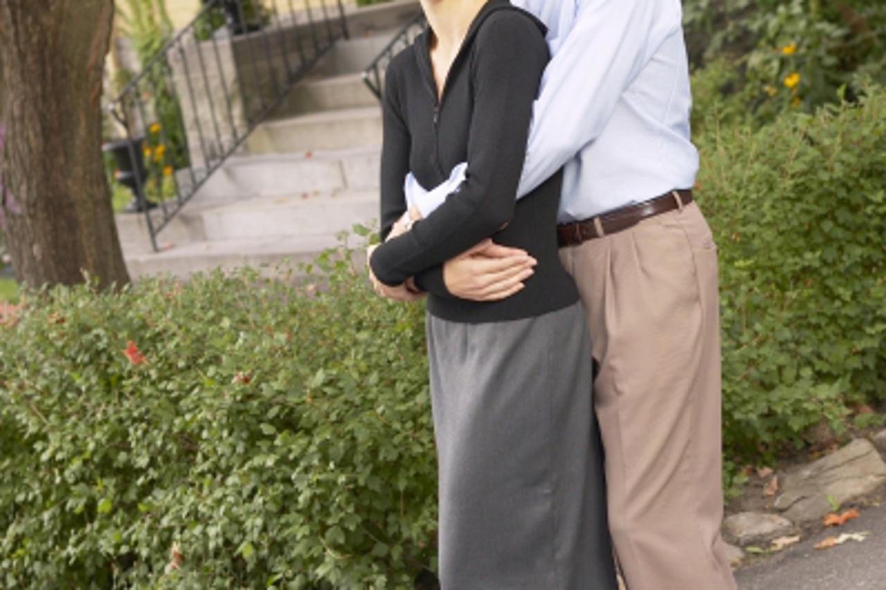 \'Couple standing in front yard\'