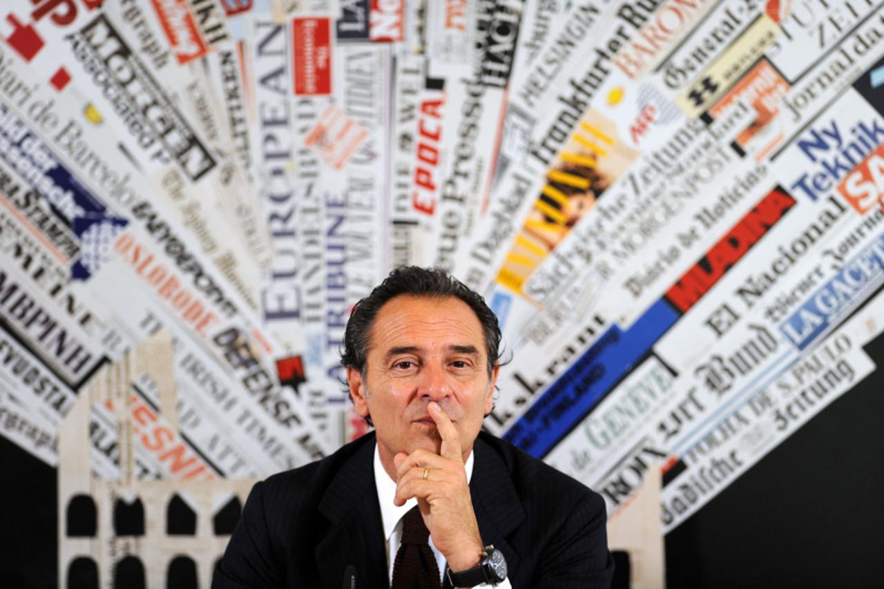 'Italy coach Cesare Prandelli listens during a press conference at the Foreign Press Club on March 21, 2012 in Rome.  Italy have booked their spot for the Euro 2012 tournament in Poland and Ukraine st