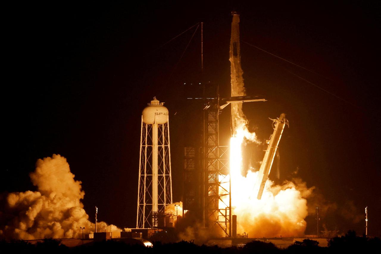 FILE PHOTO: SpaceX Falcon 9 rocket, with the Crew Dragon capsule, is launched carrying four astronauts on a mission to the International Space Station