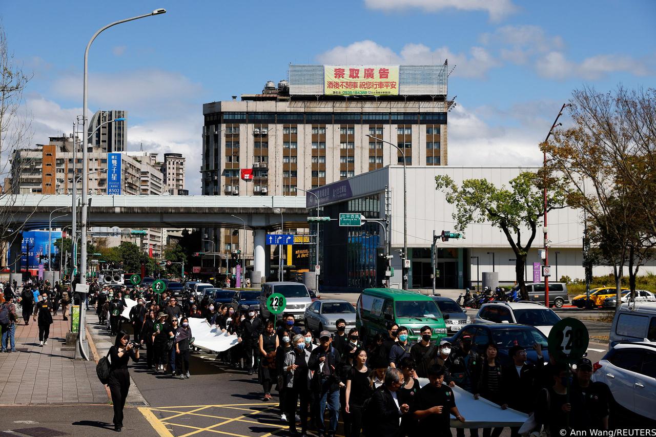 People march for the 76th anniversary of a violently suppressed anti-government uprising known as the 228 incident in Taipei,