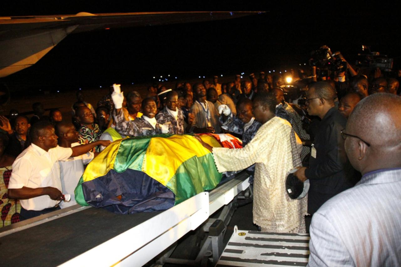 'Togolese government officials and relatives receive the remains of Togolese assistant soccer coach Amalete Abalo in the capital Lome, January 10, 2010. Togo\'s national soccer team landed back in Lom