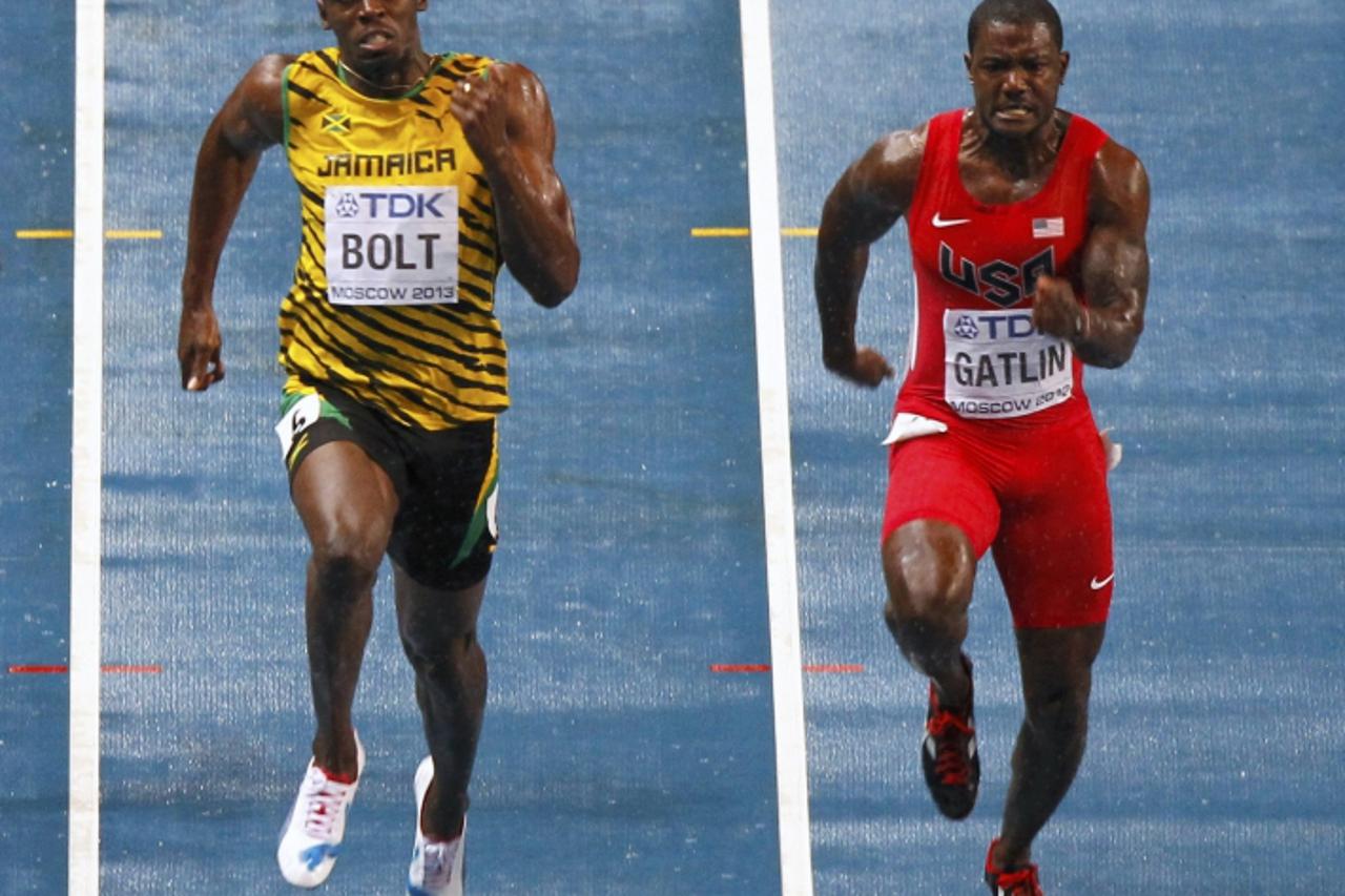 'Usain Bolt of Jamaica (L) and Justin Gatlin of the U.S. run in the men\'s 100 metres final during the IAAF World Athletics Championships at the Luzhniki stadium in Moscow August 11, 2013. REUTERS/Gar