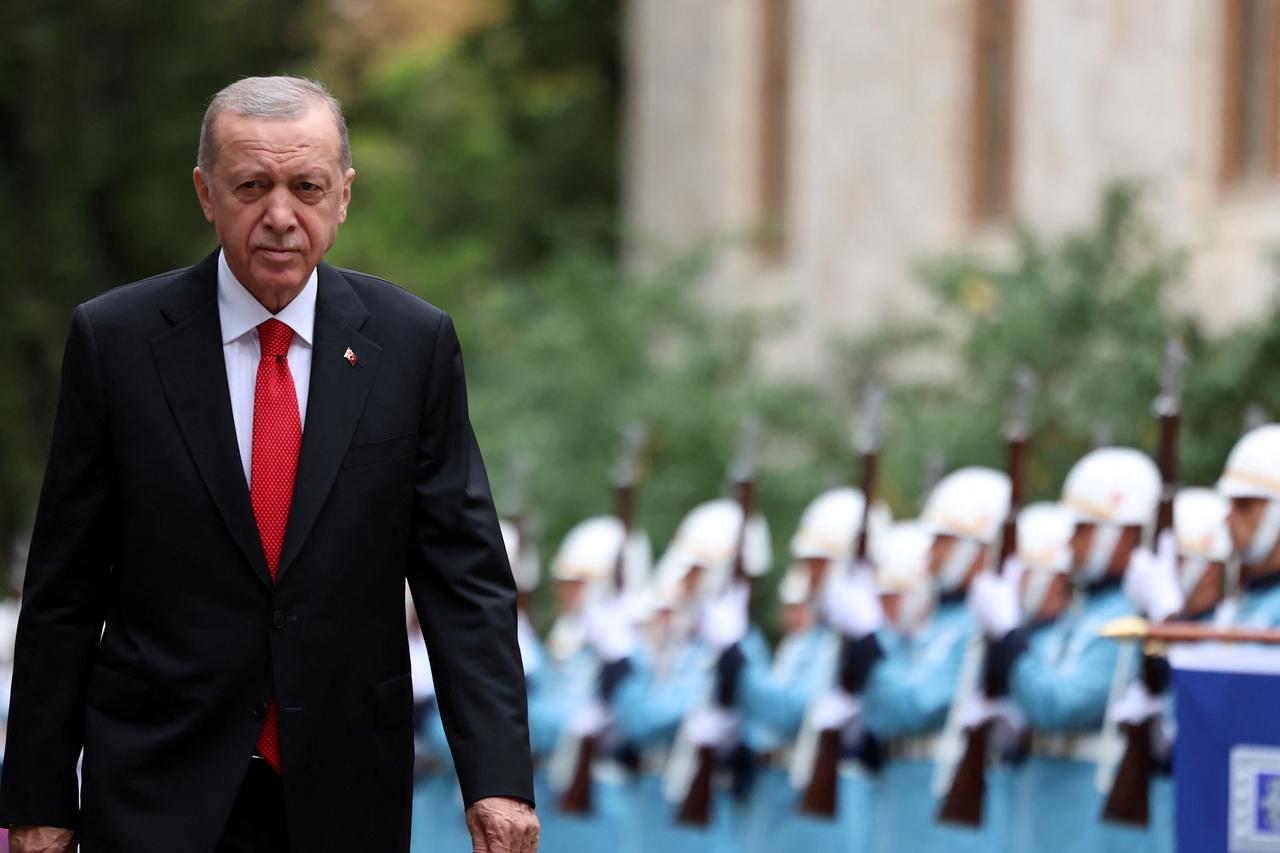 Turkey's President Tayyip Erdogan reviews a guard of honour as he attends the reopening of the Turkish parliament in Ankara