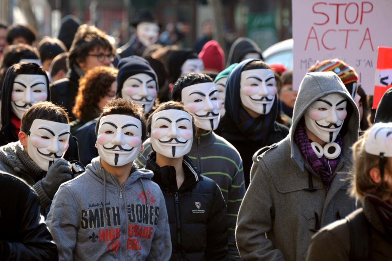 'Thousand of demonstrators wearing Anonymous Guy Fawkes masks shout slogans during a protest against the Anti-Counterfeiting Trade Agreement (ACTA) on February 11, 2012 in Paris. Protesters have adopt