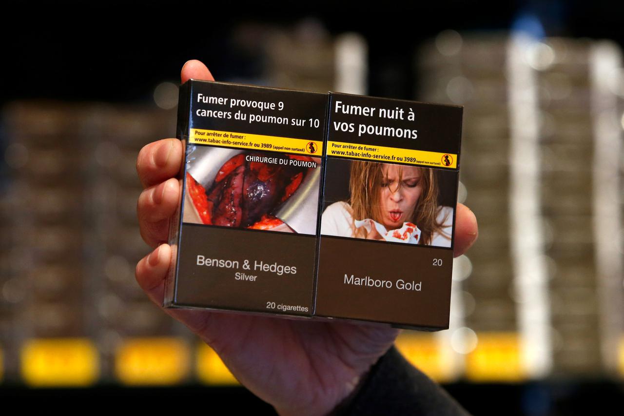 A tobacconist dispalys new cigarette packs, plain with unbranded packaging and the health warnings, 
