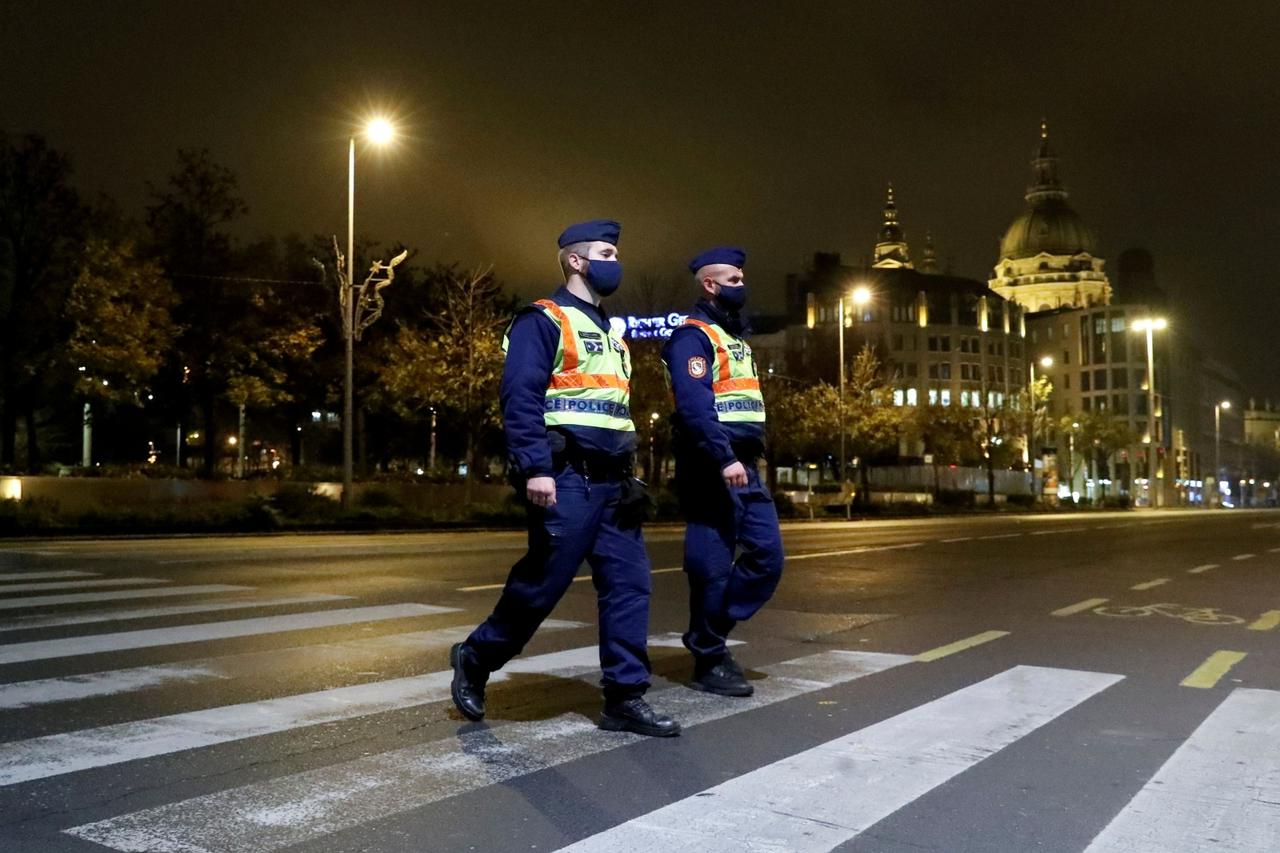 FILE PHOTO: FILE PHOTO: Police officers patrol during a night-time curfew imposed by the Hungarian government to curb the spread of the coronavirus, in Budapest, Hungary