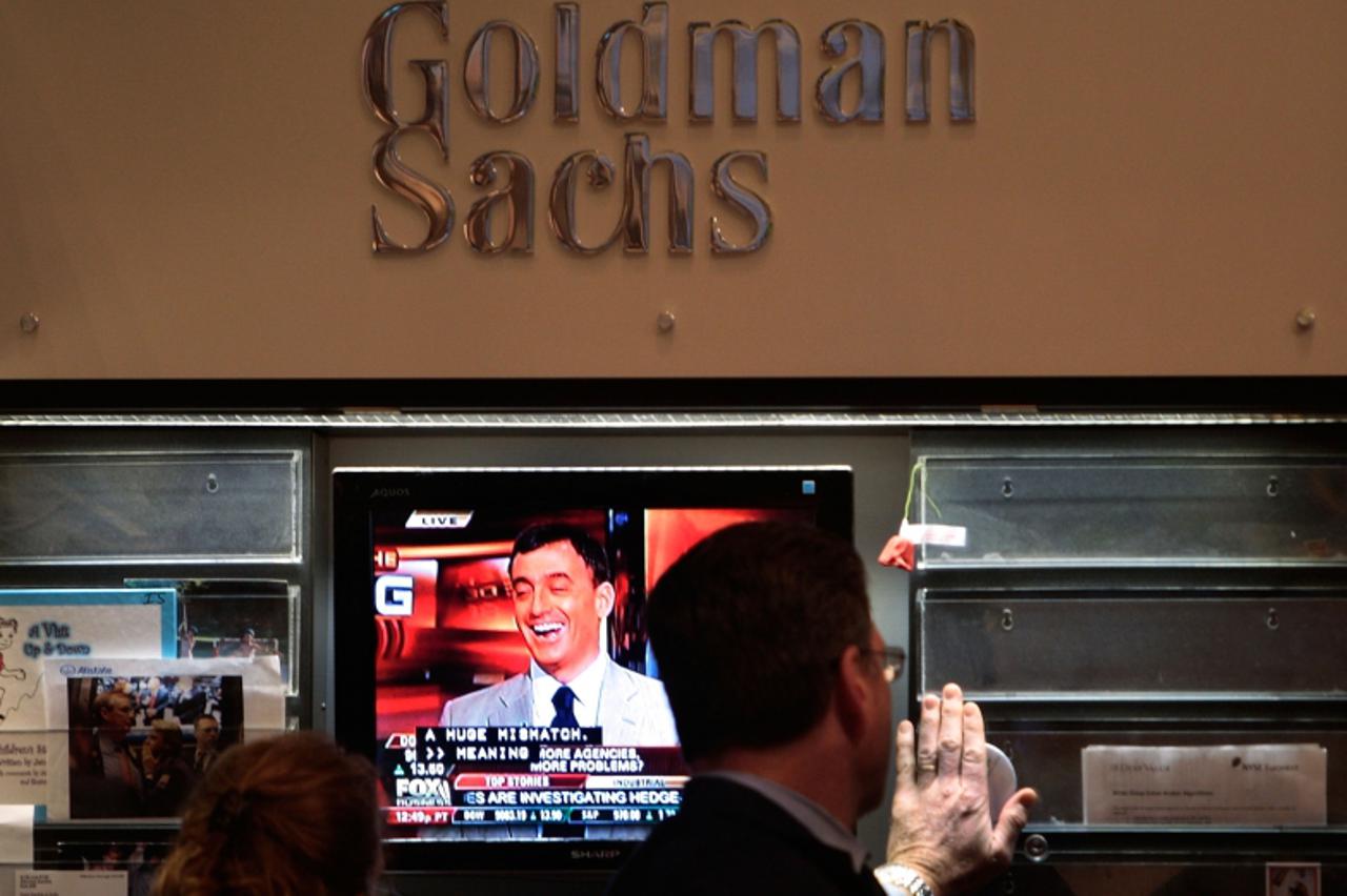 \'(FILES) Financial professionals work in the Goldman Sachs booth on the floor of the New York Stock Exchange at the end of the trading day at the July 24, 2009 in New York City. Wall Street investmen