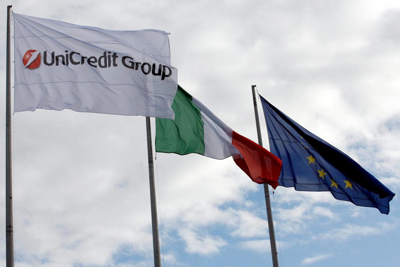FILE PHOTO: The flags of Unicredit Group, Italy and the European Union are seen at the Unicredit building in Rome