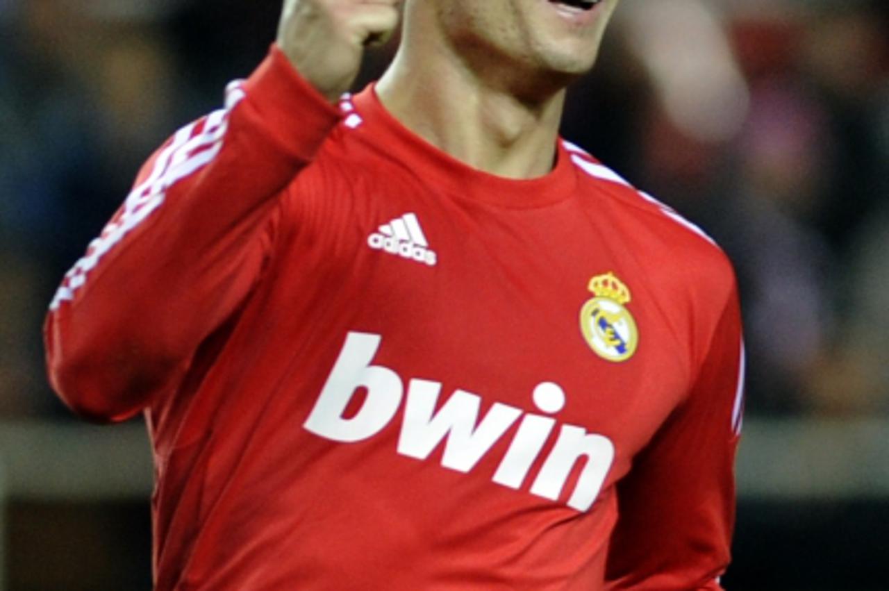'Real Madrid\'s Portuguese forward Cristiano Ronaldo celebrates after a scoring of his team against Sevilla during their Spanish League football match, on December 17, 2011 at Ramon Sanchez Pizjuan st