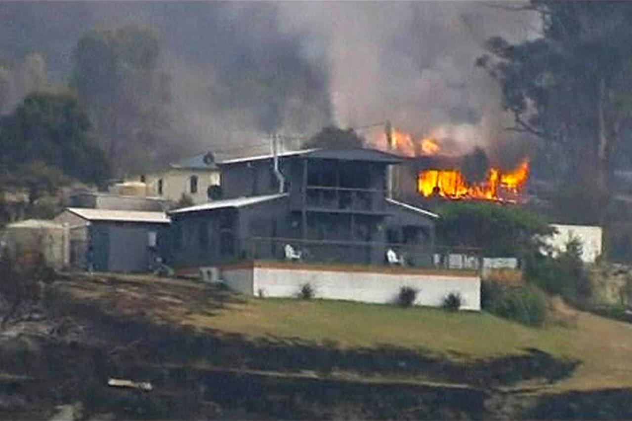 'A house is seen on fire in the Tasmanian town of Dunalley, in this still image taken from video shot January 5, 2013. Bushfires in the Tasmanian town of Dunalley have destroyed up to 80 homes, and at