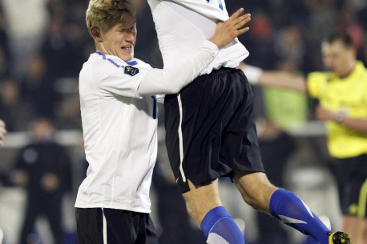 \'Ats Purje (L) and Kaimar Saag (R) of Estonia celebrate an auto-goal by Serbia\'s Aleksandar Lukovic (unseen) during their Euro 2012 qualifying soccer match in Belgrade, October 8, 2010.   REUTERS/Iv
