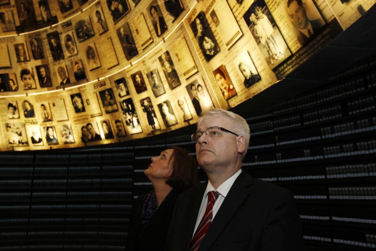 'Croatia\'s President Ivo Josipovic and his wife Tatjana look at pictures of Jews killed in the Holocaust during a visit to the Hall of Names at Yad Vashem\'s Holocaust History Museum in Jerusalem Feb