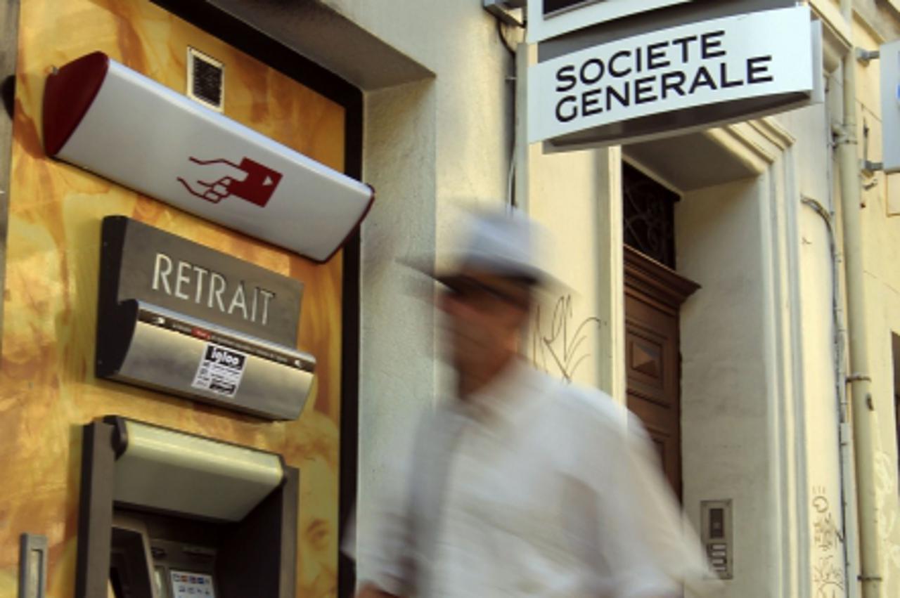 'A passer-by walks in front of cash machines of French bank Societe Generale in Marseille, September 13, 2011. Chief executive Frederic Oudea told a German financial daily newspaper that the French ba