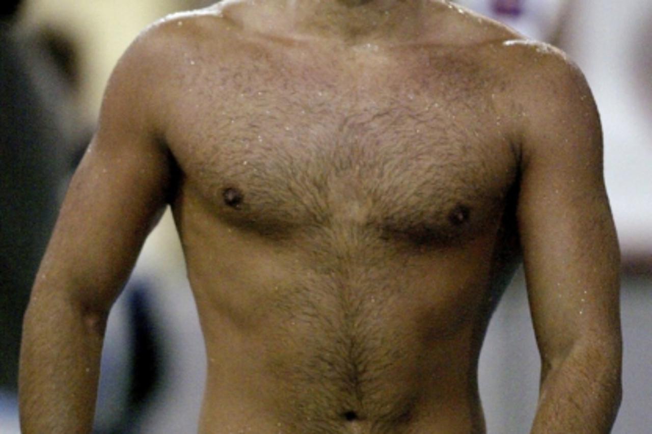 'Australian Olympic swimmer Ian Thorpe walks poolside after finishing second in the 200m freestyle event at the Brisbane Aquatic Centre, in this file picture taken July 6, 2004. Thorpe ended months of