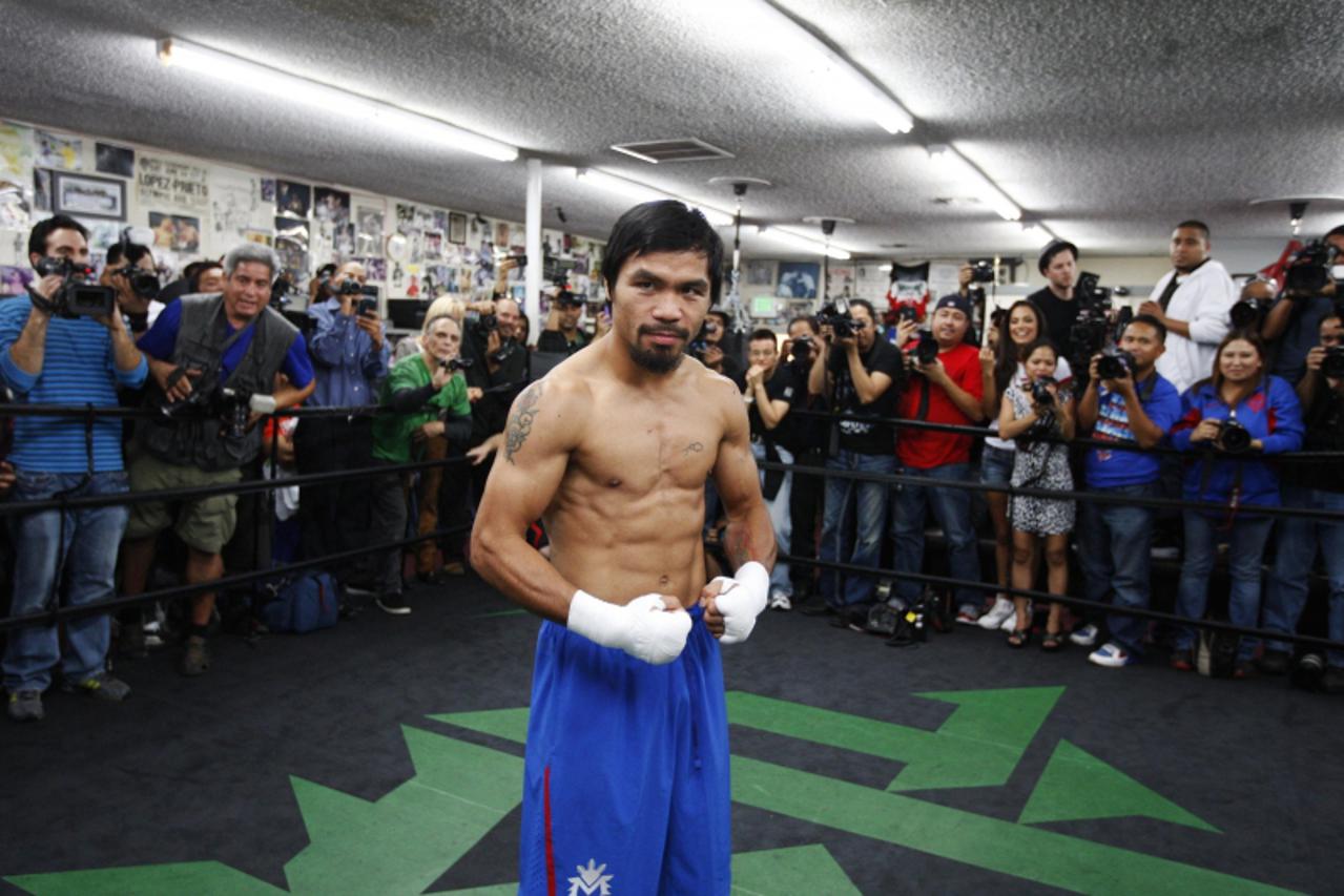 'Filipino boxer Manny Pacquiao poses for members of the media at the Wild Card Boxing Club in Los Angeles, California November 28, 2012. Pacquiao is in training to face rival Juan Manuel Marquez of Me