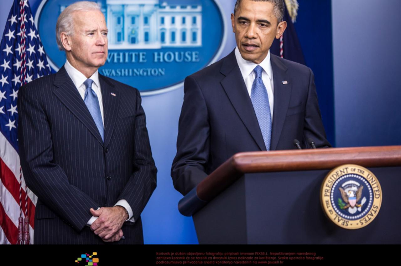 'United States Vice President Joseph R. Biden, left, looks on as U.S. President Barack Obama makes a statement in the White House Briefing Room following passage by the U.S. House of Representatives o