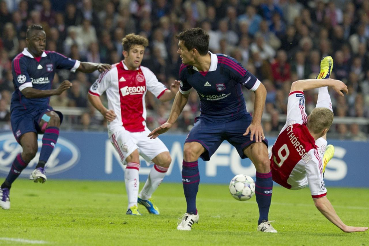 'Ajax Amsterdam player Kolbeinn Sigthorsson (R) vies for the ball with Dejan Lovren of Olympique Lyon (2nd R) during their Champions League match in Amsterdam, on September 14, 2011. AFP PHOTO / ANP /