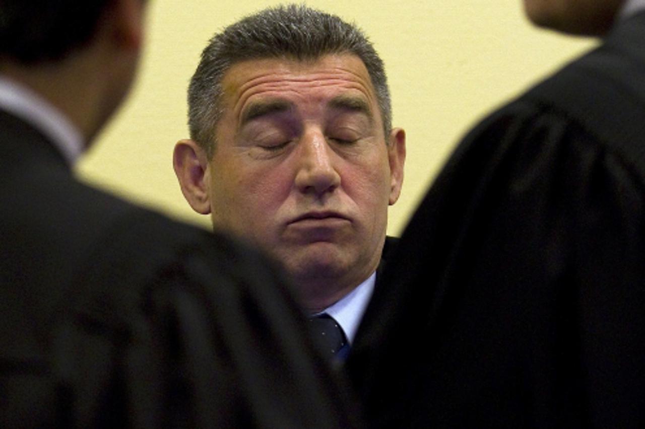 'Former Croatian Army General Ante Gotovina (C) talks to his defence team in the court room before the International Criminal Tribunal for the former Yugoslavia (ICTY) as it delivers its judgment in t