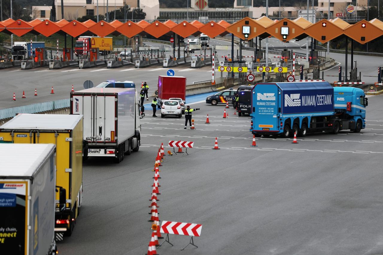 Border police prepare to inspect trucks at the last toll gate entering Spain from France, following an order from the Spanish government to set up controls at its land borders over coronavirus, in La Jonquera